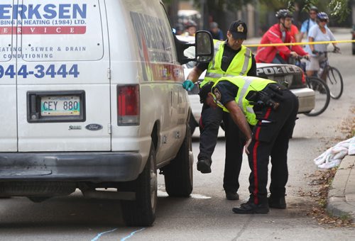 A Winnipeg Police Service traffic annalists investigate  pedestrian mva at Westminister Ave and Langside ST Wednesday morning-See Web brief- Sept 11, 2013   (JOE BRYKSA / WINNIPEG FREE PRESS)