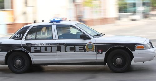 A Winnipeg Police Service cruiser car with lights and sirens responds to a call through downtown Winnipeg Wednesday morning-For files- Sept 11, 2013   (JOE BRYKSA / WINNIPEG FREE PRESS)