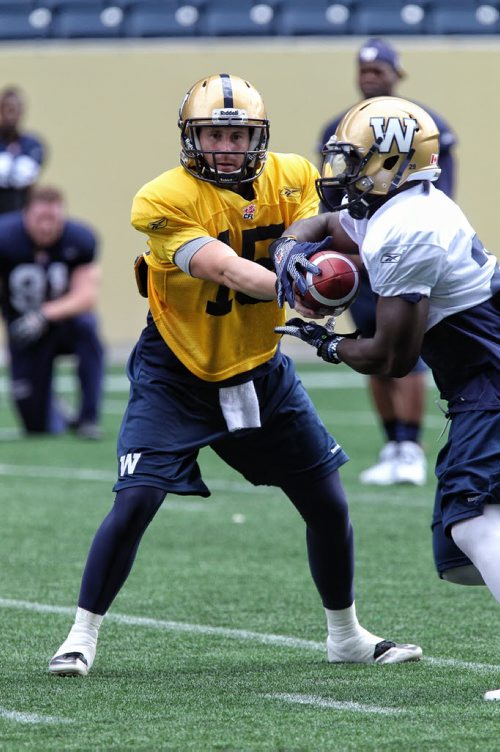 Winnipeg Blue Bombers QB Max Hall (15) hands the ball off to Carl Volny (29) during practice at Investors Group Field on Wednesday. 130911 - September 11, 2013 Mike Deal / Winnipeg Free Press