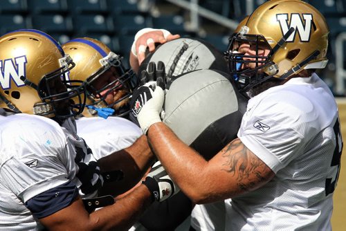 Some of the Winnipeg Blue Bombers Offensive Line practice with medicine balls Wednesday at Investors Group Field. 130911 - September 11, 2013 Mike Deal / Winnipeg Free Press