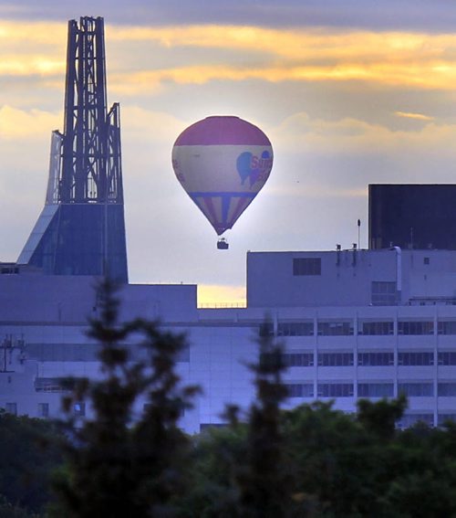 Weather story. A hot air balloon drifts past the city on a beautiful Thursday morning. Wayne Glowacki / Winnipeg Free Press Sept. 12 2013