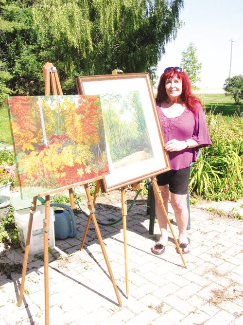 Canstar Community News Sept. 3, 2013 - Dolly Dennis shows two of her paintings that will also be displayed during the South of the Lakes Art Tour on Sept. 21 and 22. (ANDREA GEARY/CANSTAR COMMUNITY NEWS)