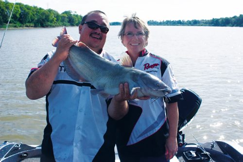 Canstar Community News Aug. 31, 2013 - WindRiver Professional Guide Services founders Frank and Dorothy Normand are shown with a catfish caught on the Red River near Selkirk on Aug. 31. (DAN FALLOON/CANSTAR COMMUNITY NEWS/HERALD)