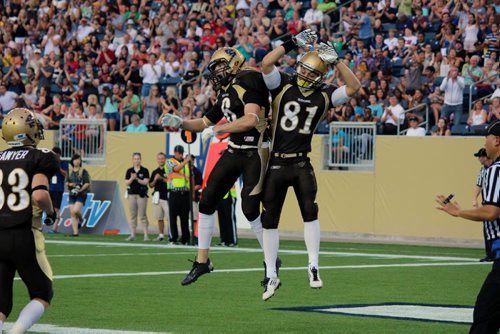 Canstar Community News Manitoba Bisons wide receivers Andrew Smith (left) and Christian Hansen celebrate a touchdown to the cheers of fans at Investors Group Field. JORDAN THOMPSON/CANSTAR COMMUNITY NEWS