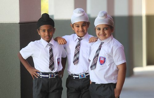 Young Sikh  students (boys) have some fun as they goof around outside their school  at Punjab Cultural Centre.  Names Sehaj Singh (Black Turban), Bharjaheen Singh  (chubby) and Baljot Singh (wearing no school crest). Story by Carol Sanders Sept  12,, 2013 Ruth Bonneville Winnipeg Free Press