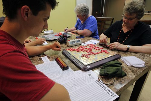 Winnipeg Scrabble Club meets every Thurs at the Kenaston Village Rec Centre. 2013 marks the 75th anniversary of the invention of Scrabble. Calvin Dick plays against Julie Kading. on left back is Linda Pearn(centre in photo). BORIS MINKEVICH / WINNIPEG FREE PRESS. Sept. 12, 2013