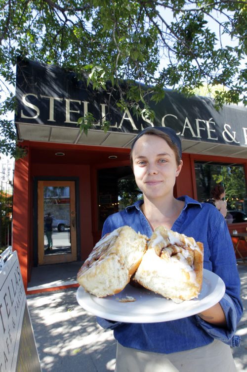This is for a story celebrating National Cinnamon Bun Day. Rachel Braul from Stells's poses with some buns. BORIS MINKEVICH / WINNIPEG FREE PRESS. Sept. 13, 2013