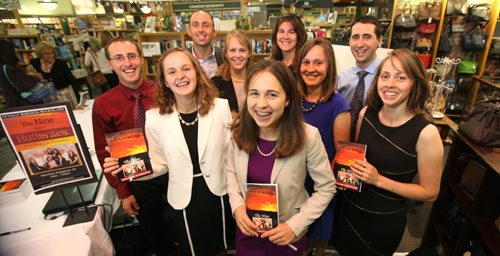 Members of the group of Nine, ex-Hutterites pose for a quick photo in-between signing copies of their book  Hutterites Tell-All at McNally Robinson Saturday afternoon.   Names from left -  Jason Waldner (red) Rodney Waldner (rear left), Karen Waldner (blond), Glenda Maendel (back centre, brown) Junia Waldner (blue), Titus Waldner, Darlene Waldner (black) and Sheryl Waldner (front centre, purple). Sept  14,, 2013 Ruth Bonneville Winnipeg Free Press