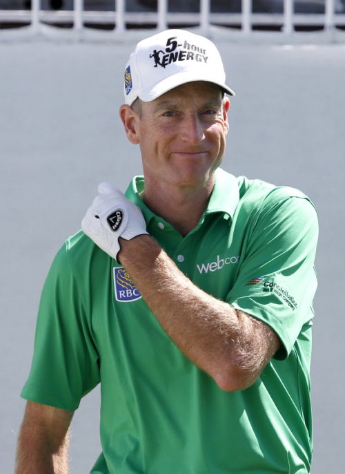 Jim Furyk smiles as he prepares to hit his tee shot on the first hole during the third round of the BMW Championship golf tournament at Conway Farms Golf Club in Lake Forest, Ill., Saturday, Sept. 14, 2013. (AP Photo/Charles Rex Arbogast)