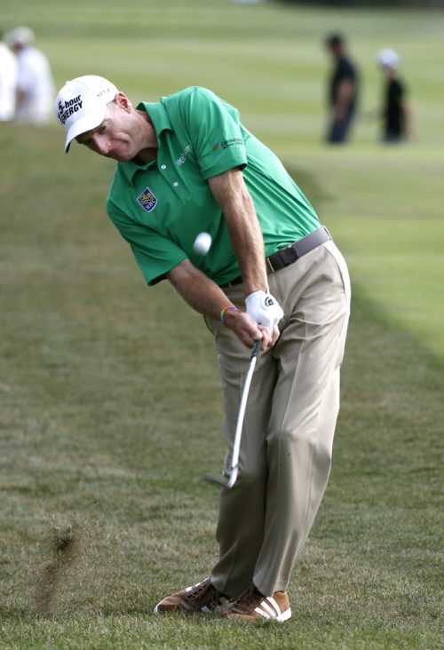 Jim Furyk hits his approach shot to the 18th green during the third round of the BMW Championship golf tournament at Conway Farms Golf Club in Lake Forest, Ill., Saturday, Sept. 14, 2013. (AP Photo/Charles Rex Arbogast)