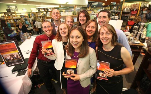 Members of the group of Nine, ex-Hutterites pose for a quick photo in-between signing copies of their book  Hutterites Tell-All at McNally Robinson Saturday afternoon.   Names from left -  Jason Waldner (red) Rodney Waldner (rear left), Karen Waldner (blond), Glenda Maendel (back centre, brown) Junia Waldner (blue), Titus Waldner, Darlene Waldner (black) and Sheryl Waldner (front centre, purple) and Cindy Waldner (cream and black). Sept  14,, 2013 Ruth Bonneville Winnipeg Free Press