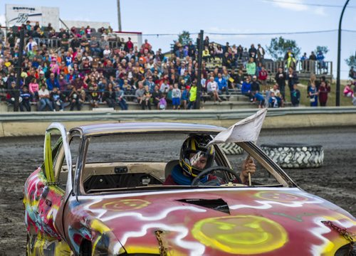 130914 Winnipeg - DAVID LIPNOWSKI / WINNIPEG FREE PRESS (September 14, 2013)  A driver waves his white flag signifying that he is out of the race during action from the 4th Annual Teen Challenge Demolition Derby at Red River Co-op Speedway Saturday afternoon.  Daring drivers drove donated vehicles prepared by Teen Challenge students and graduates. Proceeds from the event went towards the addiction recovery and awareness programs offered by Teen Challenge of Central Canada.