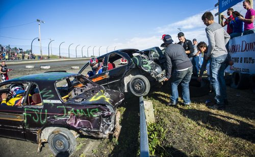 130914 Winnipeg - DAVID LIPNOWSKI / WINNIPEG FREE PRESS (September 14, 2013)  One car was hit so hard, it jumped the protective railing, almost injuring spectators and judges during action from the 4th Annual Teen Challenge Demolition Derby at Red River Co-op Speedway Saturday afternoon.   Daring drivers drove donated vehicles prepared by Teen Challenge students and graduates. Proceeds from the event went towards the addiction recovery and awareness programs offered by Teen Challenge of Central Canada.