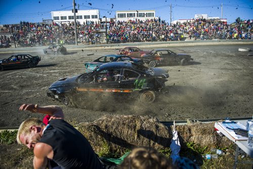 130914 Winnipeg - DAVID LIPNOWSKI / WINNIPEG FREE PRESS (September 14, 2013)  An out of control car losing a tire hurls dirt and debris at spectators and judges during action from the 4th Annual Teen Challenge Demolition Derby at Red River Co-op Speedway Saturday afternoon.   Daring drivers drove donated vehicles prepared by Teen Challenge students and graduates. Proceeds from the event went towards the addiction recovery and awareness programs offered by Teen Challenge of Central Canada.