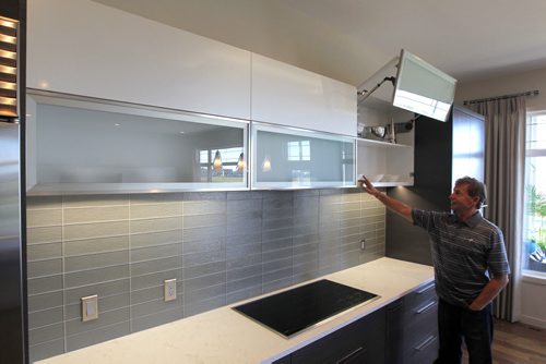 HOMES - 192 Lake Bend Road in Bridgwater Lakes.  Rob Swan in the kitchen demonstrating the Blum automatic hinge system in the citchen BORIS MINKEVICH / WINNIPEG FREE PRESS. Sept. 16, 2013