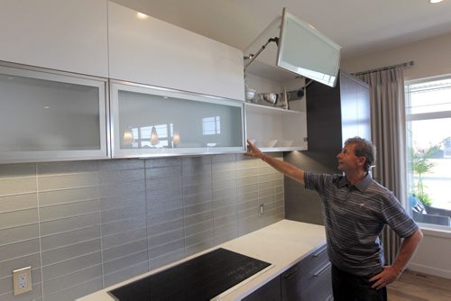 HOMES - 192 Lake Bend Road in Bridgwater Lakes.  Rob Swan in the kitchen demonstrating the Blum automatic hinge system in the citchen BORIS MINKEVICH / WINNIPEG FREE PRESS. Sept. 16, 2013