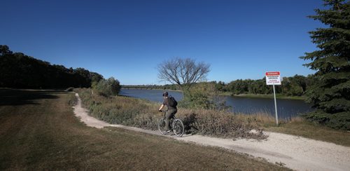 Cyclists move along a former riverside fairway at the old Southwood Golf Course property. .....See story re: re-development by Bart Kives. September 16, 2013 - (Phil Hossack / Winnipeg Free Press)
