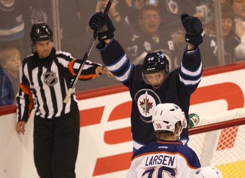 Winnipeg Jets Carl Klingberg celebrates second period goal as Edmonton Oilers Phillip Larsen looks on during NHL pre-season action at the MTS Centre in Winnipeg Tuesday night -See Jets stories- Sept 17, 2013   (JOE BRYKSA / WINNIPEG FREE PRESS)