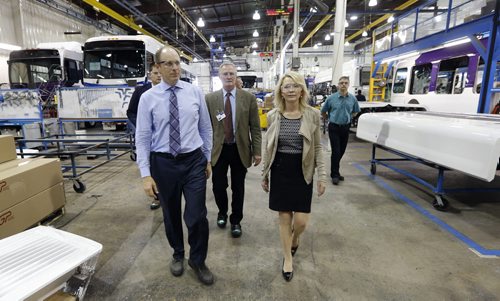 New Flyer bus assembly line - (right front) Candice  Bergen Minister of State and Social Development  toured the  New Flyer bus plant in Transcona  with  (left front) New  Flyer's  David White Executive  Vp of Suply Management  as part of a cross country tour supporting  Canadian manufacturers , in pic  KEN GIGLIOTTI / SEPT 18 2013 / WINNIPEG FREE PRESS