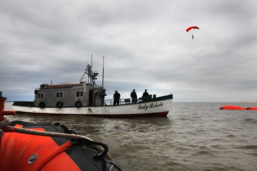 SAREX Marine Rescue Search and Rescue personal team up with the Canadian Coast Guard and Canadian Forces in Gimli Wednesday to perform a mock rescue of a fishing vessel with a trauma victim (with eyeball out of socket) on board their  vessel.  The SARTech responders had to parachute from a hercules airplane into Lake Winnipeg near the stranded boat and climb aboard their vessel to accomplish their mission.  After applying first aid they manage to bring casualty back to Gimli harbour.  Mission accomplished.    See Ashley Priest story. Sept  18,, 2013 Ruth Bonneville Winnipeg Free Press