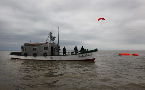 SAREX Marine Rescue Search and Rescue personal team up with the Canadian Coast Guard and Canadian Forces in Gimli Wednesday to perform a mock rescue of a fishing vessel with a trauma victim (with eyeball out of socket) on board their  vessel.  The SARTech responders had to parachute from a hercules airplane into Lake Winnipeg near the stranded boat and climb aboard their vessel to accomplish their mission.  After applying first aid they manage to bring casualty back to Gimli harbour.  Mission accomplished.    See Ashley Priest story. Sept  18,, 2013 Ruth Bonneville Winnipeg Free Press