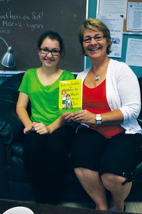 Canstar Community News Sept. 11, 2013 - River East Transcona School DIvision educational assistant Shannon Schultz. who authored Faith has Freckles and Walter has Wheels. But did you know... is shown with Murdoch MacKay Collegiate student Abby Turczak, who does readings of the book for young students. (DAN FALLOON/CANSTAR COMMUNITY NEWS/HERALD)