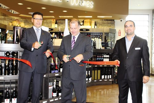 Canstar Community News From left: Al Roney, executive general manager, retail stores, Manitoba Liquor & Lotteries; Jim Rondeau, minister responsible for The Liquor Control Act; and Jason Boyda, store manager cut the ribbon to officially open Winnipeg's newest Liquor Mart, located in Fort Richmond at the corner of Pembina Highway and Kirkbridge Drive.