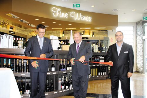 Canstar Community News From left: Al Roney, executive general manager, retail stores, Manitoba Liquor & Lotteries; Jim Rondeau, minister responsible for The Liquor Control Act; and Jason Boyda, store manager cut the ribbon to officially open Winnipeg's newest Liquor Mart, located in Fort Richmond at the corner of Pembina Highway and Kirkbridge Drive.
