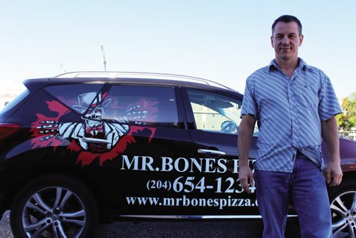 Canstar Community News Harold Brazil, founder of Mr. Bones Pizza, with the 'Bonesmobile.' Brazil is working on resurrecting the pizza restaurant, which operate from 1027 McPhillips St. JORDAN THOMPSON/Canstar Community News