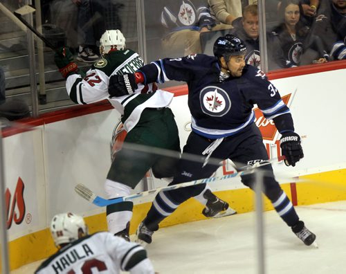 Winnipeg Jet Defenceman Dustin Byfuglien keeps Minnesota WIld's #22Nino Niederreiter out of the play behind the jet's net in first period action THursday. ....See story. September 19, 2013 - (Phil Hossack / WInnipeg Free Press)