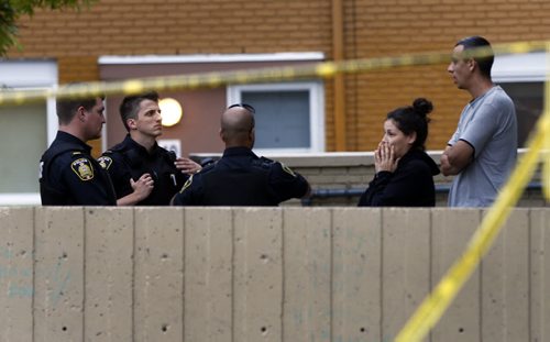 Police talk to witnesses  near crime scene where a man was beaten and stabbed- Wpg City Police investigate fight  that occurred at Lord Selkirk Park  a  Man. Housing project common area  on Robinson St that left one person dead  KEN GIGLIOTTI / SEPT 20 2013 / WINNIPEG FREE PRESS