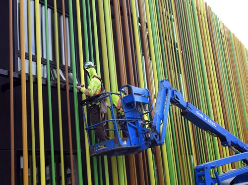 Workers install the colourful pipes on Sunstone's three-storey, 67-room Boutique Hotel, Cafe and Wine Bar under construction along the Red River on Waterfront Drive near James Ave. Friday.  Wayne Glowacki / Winnipeg Free Press Sept. 20 2013