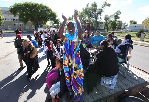Nine year old Fatuma Mhamud claps while standing on a float during the  7th annual Medicine Walk in the North End near Selkirk Ave Saturday afternoon.  'Grandmothers protecting our children" is a march to raise awareness of the abuse of children.  See Story.   Sept  21,, 2013 Ruth Bonneville Winnipeg Free Press