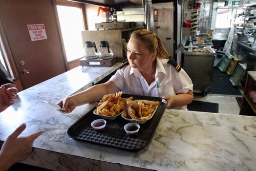 Anita Procter serves up the classic cruise snack, chicken fingers and fries with sauce as the Paddlewheel Queen cruised the Red River for the last time this year. 130922 September 22, 2013 MIKE DEAL / WINNIPEG FREE PRESS