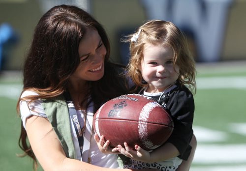 Winnipeg Blue Bomber QB Max Hall's wife McKinzi and his 2 year old daughter Hayden horse around on Investors Group field after practice Tuesday. Standup sports. Sept  24,, 2013 Ruth Bonneville Winnipeg Free Press