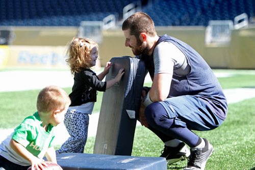 Winnipeg Blue Bomber QB Max Hall - #15 spends some time with his kids - 3 year old Rex,2 year old Hayden and his wife McKinzi on Investors Group field after practice Tuesday. Standup sports. Sept  24,, 2013 Ruth Bonneville Winnipeg Free Press