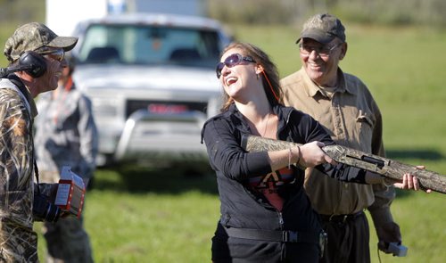 Manitoba Wildlife Federation's Women's waterfowl hunt. Rebecca Tremeer is coached by shooting instructors Fred Tait, right, and Rob Wyton, far left. BORIS MINKEVICH / WINNIPEG FREE PRESS. Sept. 21, 2013