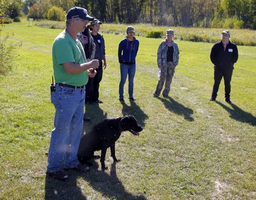 Manitoba Wildlife Federation's Women's waterfowl hunt. Peter Menge from MB Gun Dogs with his hunting dog named Sniper put on a demonstration on training hunting dogs. BORIS MINKEVICH / WINNIPEG FREE PRESS. Sept. 22, 2013