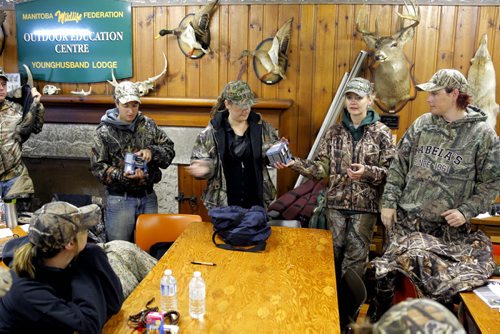 Manitoba Wildlife Federation's Women's waterfowl hunt.  Ammunition is handed out to the hunters before they leave the lodge in the morning. BORIS MINKEVICH / WINNIPEG FREE PRESS. Sept. 22, 2013