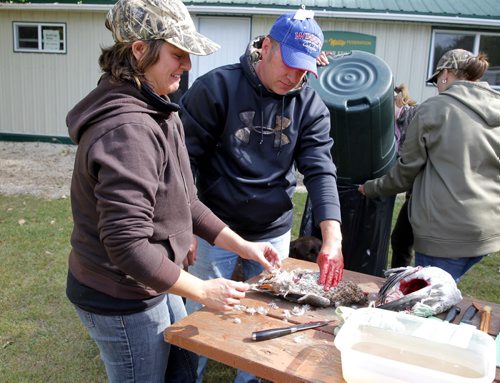 Manitoba Wildlife Federation's Women's waterfowl hunt. Cameron Tait, right, teaches Robyn Schantz, left, how to butcher a bird taken earlier in the morning. BORIS MINKEVICH / WINNIPEG FREE PRESS. Sept. 22, 2013