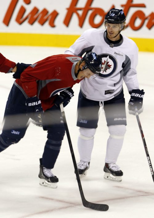 opps - D #4 John Erskine take hard shot from  Bryan Little  #18 during practice - Erskine did not want to leave the ice  but returned after injury was ck'ed out .   Winnipeg Jets practice at MTS Centre  KEN GIGLIOTTI / SEPT 25 2013 / WINNIPEG FREE PRESS