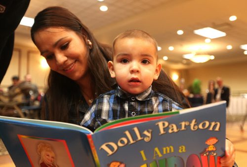 One year old Draven Campbell receives a free book called - I am a Rainbow, through the Dolly Pardon Imagination Library foundation which announced 7,000 more books for First Nation Communities  at a press conference in Winnipeg Wednesday. Bill Redekop story. Sept  25,, 2013 Ruth Bonneville Winnipeg Free Press