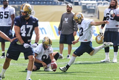 Winnipeg Blue Bombers punter, Mike Renaud (9) holds the ball while kicker, Sandro DeAngelis (12) goes for a field goal during practice at Investors Group Field Wednesday afternoon. 130925 - September 25, 2013 MIKE DEAL / WINNIPEG FREE PRESS