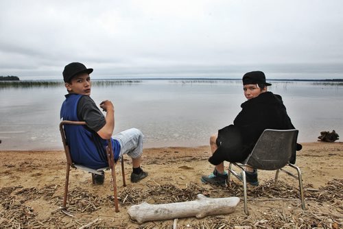 September 18th - Brothers Samuel Parenteau (left) and Jericho (right) from Duck Bay take a break on the beach at Egg Lake. Students take part in the Engaged Learners Program, where over the course of three 12-day sessions they will take part in workshops on building construction, electrical, plumbing, emergency fire fighting, hair dressing, jewelry making, early childhood and physical education. This session of boys (approximately an equal number of girls will gather in separate 12-day sessions) come from all over Northern Manitoba and have for one reason or another stopped going to school. The Frontier Engaged Learners Centre, located at Egg Lake about 25 km south of Cranberry Portage, MB. 130925 - September 25, 2013 MIKE DEAL / WINNIPEG FREE PRESS