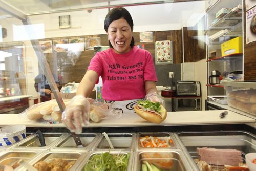 Trinh Le owner of K & W Grocery and Convenience  makes tasty, Vietnamese subs and sticky rice next to her grocery store on Dufferin.  Food Front. Sept  26,, 2013 Ruth Bonneville Winnipeg Free Press