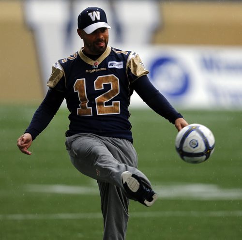 Practicing in the rain Äì K #12 Sandro DeAngelis   stays loose with soccer ball during walk through practice -  Wpg Blue Bombers prepare for BC Lions Friday night at Investors Stadium  KEN GIGLIOTTI / SEPT 26 2013 / WINNIPEG FREE PRESS
