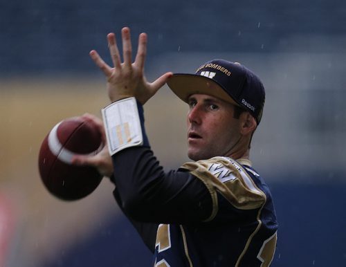 QB Max Hall keeps his arm loose during light rainy practice at Investors Group Staduim walk through -Practicing in the rain  Wpg Blue Bombers prepare for BC Lions Friday night at Investors Stadium  KEN GIGLIOTTI / SEPT 26 2013 / WINNIPEG FREE PRESS