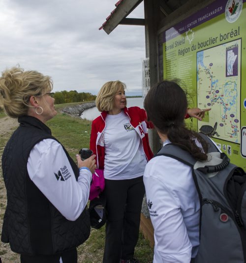 Honourary Campaign Chair of the Trans Canada Trail, Laureen Harper (centre), Minister of Canadian Heritage and Official Languages, Shelly Glover (left), and VP of Trails Manitoba, Marissa Zerba hike the new section of Border to Beaches trail in the Whiteshell Friday morning. (Photograph by: David Lipnowski for Trails Manitoba)