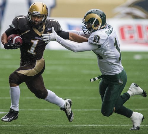 130928 Winnipeg - DAVID LIPNOWSKI / WINNIPEG FREE PRESS (September 28, 2013)  University of Manitoba Bisons Anthony Coombs (#1) tries to evade the University of Regina Rams at Investors Group Field Saturday afternoon. The Bisons defeated the Rams 34-15.