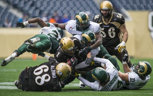 130928 Winnipeg - DAVID LIPNOWSKI / WINNIPEG FREE PRESS (September 28, 2013)  University of Manitoba Bisons Anthony Coombs (#1) gets caught up with the University of Regina Rams at Investors Group Field Saturday afternoon. The Bisons defeated the Rams 34-15.